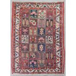 A Bakhtiar rug woven in colours with stylized Persian garden design, 77ins x 55ins