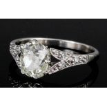 An Edwardian silvery coloured metal mounted diamond solitaire ring, the oval old cut stone