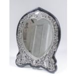 A late Victorian silver dressing table mirror, the frame applied with shaped mount, pierced and