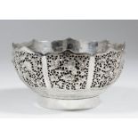 A Chinese silvery metal circular bowl with shaped rim and double walled panels, the exteriors