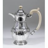 A 20th Century Indian silver hot water jug of early 18th Century English design, the slightly