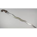 A 19th Century Indian "Nagan" or serpentine sword, the undulating 27ins blade engraved with a tribal