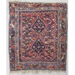 A Qashqai rug, woven in muted colours and ivory with stepped double headed medallion, stylised