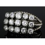 A modern silvery coloured metal mounted all diamond set ring, the face set with fifteen brilliant