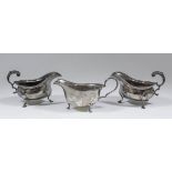 A pair of George V silver oval sauce boats with reeded and leaf cast mounts, leaf capped double C-