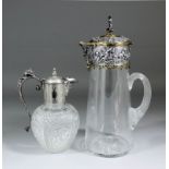 A Victorian water jug by Elkington & Co, the plain tapered clear glass body with star cut base and