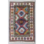 A mid 20th Century Caucasian Borchalu rug woven in colours with overlapping hooked medallions on a