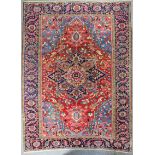 An antique Heriz carpet, woven in colours with double headed star shaped medallion, conforming