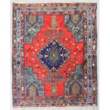 An antique Afshar rug, woven in muted colours and ivory with central stepped medallion, spandrals