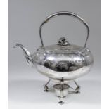 A George V silver bulbous tea kettle with plain arched handle and floral knop to lid, the bulbous