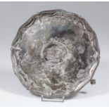 A George III silver circular waiter of "Adam" design, the shaped rim with bead and swag mounts, on