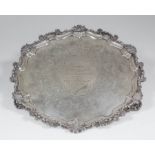 A Victorian silver circular salver, the shaped and moulded rim with shell and scroll cast mounts,