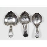 A George III silver caddy spoon with cartouche shaped bowl and pierced handle engraved with floral