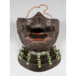 A Japanese lacquered leather Menpo (face guard) with detachable nose and horse-hair moustache in the