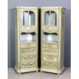 A pair of 19th Century French green painted cabinets with canted front corners, each decorated in