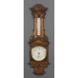 A late 19th Century oak cased aneroid barometer and thermometer retailed by W. Gregory & Co, 51