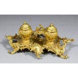 A late 19th/early 20th Century Continental gilt brass inkstand of rococo design with two lidded