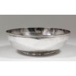 A 19th century French plain silvery metal circular bowl with moulded rim and footrim, 10.375ins x