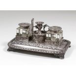 A George V silver rectangular inkstand with leaf cast rim, and scroll floral, leaf and vine cast