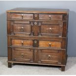 A 17th Century oak chest of drawers in two sections, with moulded edge to top, fitted four long