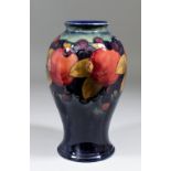 A Moorcroft pottery baluster shaped vase tube lined and decorated in colours with "Pomegranate"