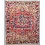 A Heriz carpet woven in colours with central star shaped double headed medallion, spandrels and