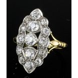A 1920s 18ct white and yellow gold mounted diamond set ring, the marquise pattern face set with
