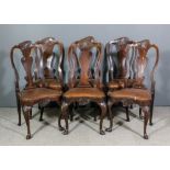 A set of six 18th Century Dutch walnut dining chairs with shaped and leaf carved crest rails, shaped