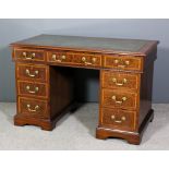 An Edwardian mahogany kneehole desk, the whole inlaid with rosewood bandings and boxwood stringings,