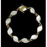 A modern 9ct gold mother of pearl set leaf pattern link bracelet, the ten stylised leaf pattern