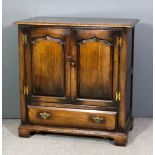 A panelled oak television cabinet in the manner of Titchmarsh & Goodwin, with moulded edge to top,