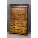 A mid 18th Century walnut secretaire a abattant the upper part with moulded cornice above single