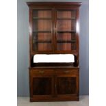 A late Victorian mahogany bookcase, the upper part with moulded cornice, fitted three adjustable