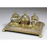 A late 19th Century Continental brass and copper electrotype inkstand with two glass inkwells, 9.