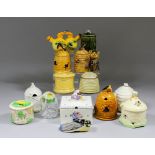 A small collection of ceramic honey pots and bee related items, including - Poole pottery box and