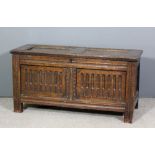 An 18th Century panelled oak coffer with stop fluted linenfold panels to front, on stile support,