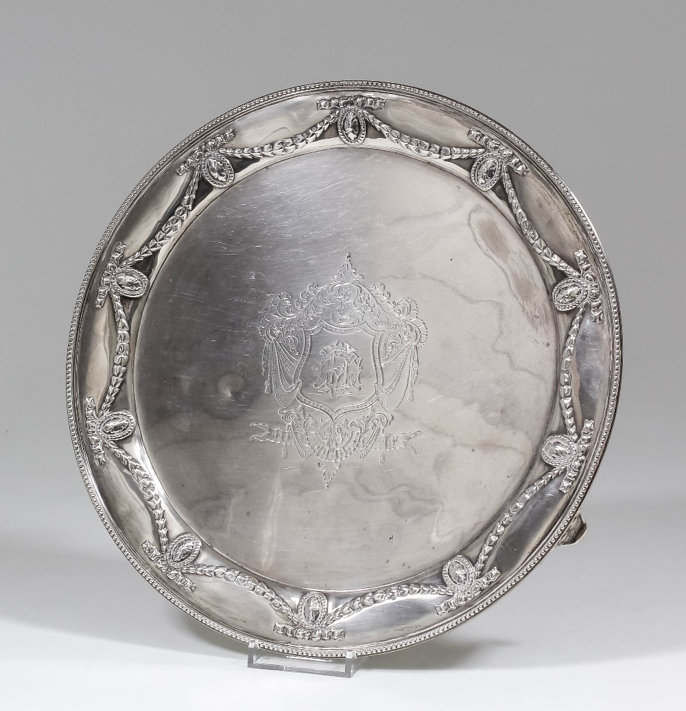 A late Victorian silver circular salver of Neo-classical design, the rim embossed with oval paterae,