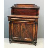 An early Victorian mahogany chiffonier, the upper part with open shelf, on turned supports, fitted