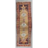 A Sarape runner woven in colours with a central pole medallion with three lozenge shaped panels,