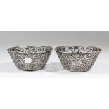 Two Chinese silver circular bowls of tapered form, pierced and cast with birds and bamboo shoots,