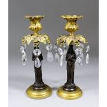 A pair of late 19th/early 20th Century Continental ormolu and bronze pillar candlesticks with leaf