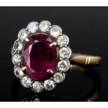 A 1960s 14k white and yellow gold mounted ruby and diamond ring, the oval cut ruby approximately 1.