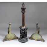 A bronze lamp base modelled in the form of four putti and a goat supporting a turned and carved