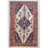 A Backtiari rug woven in colours with a central pole medallion with stylised trailing floral motifs,