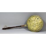 A late 17th Century Dutch brass warming pan, the lid pierced and embossed with a bust of a man,