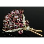 A 1960s gold and silvery coloured metal mounted garnet and diamond set spray pattern brooch, the