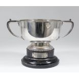 A George V silver circular two-handled trophy with angular handles, on circular footrim with bead