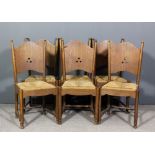 A set of six early 20th Century oak dining chairs of Arts & Crafts design, the arched backs each