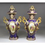 A pair of 19th Century English porcelain octagonal baluster shaped vases and covers with rococo