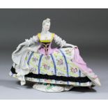 A 20th Century German porcelain figure of a fine lady in 18th Century dress after a Meissen